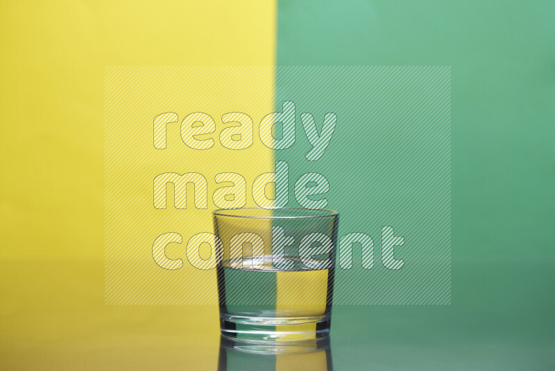 The image features a clear glassware filled with water, set against yellow and green background