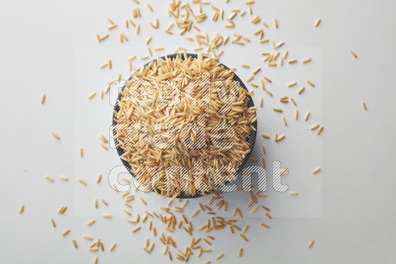 Long grain brown rice on white background