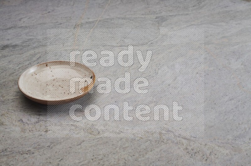 Multicolored Pottery Plate On Grey Marble Flooring