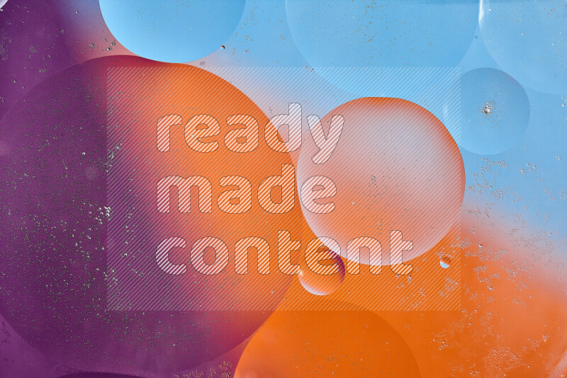 Close-ups of abstract oil bubbles on water surface in shades of blue, orange and purple