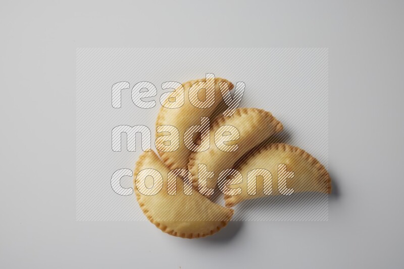 Four fried sambosa from a top angle on a white background