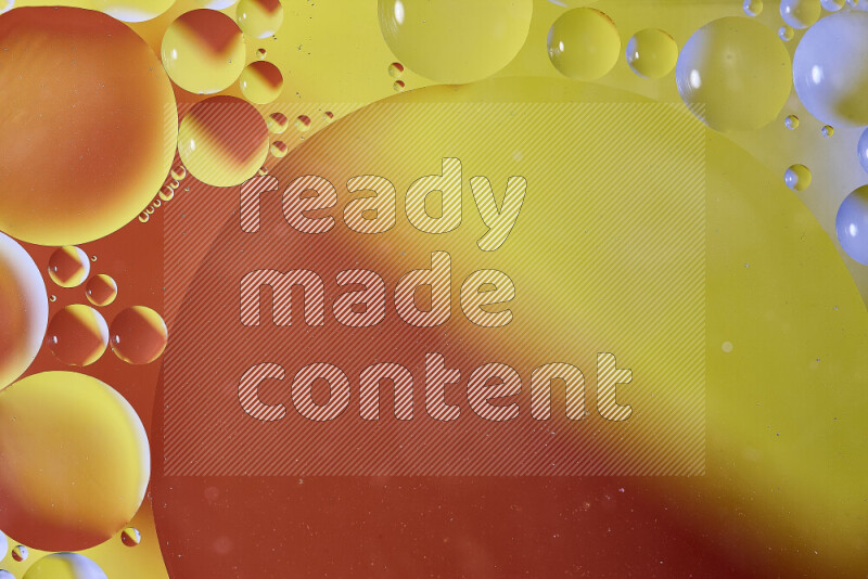 Close-ups of abstract oil bubbles on water surface in shades of orange and yellow