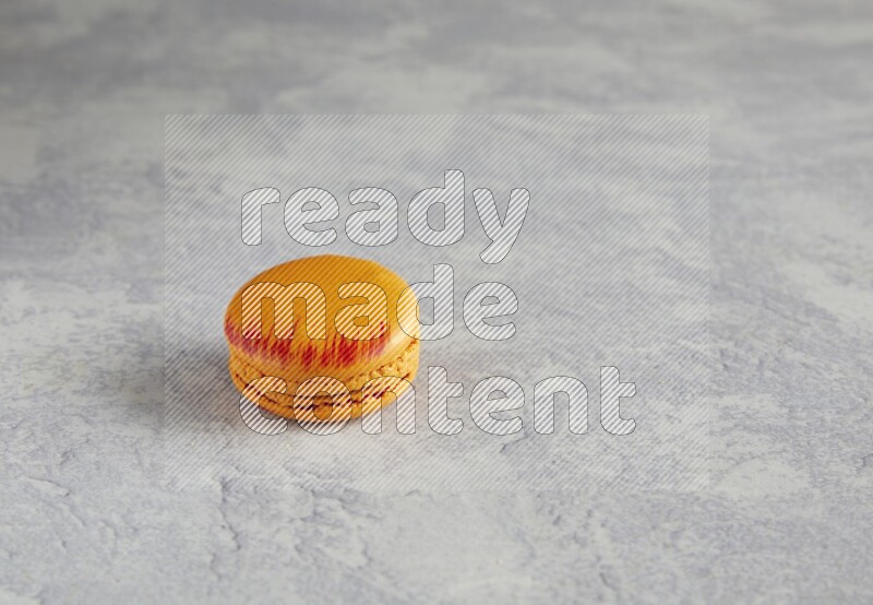 45º Shot of Orange Exotic macaron on white  marble background