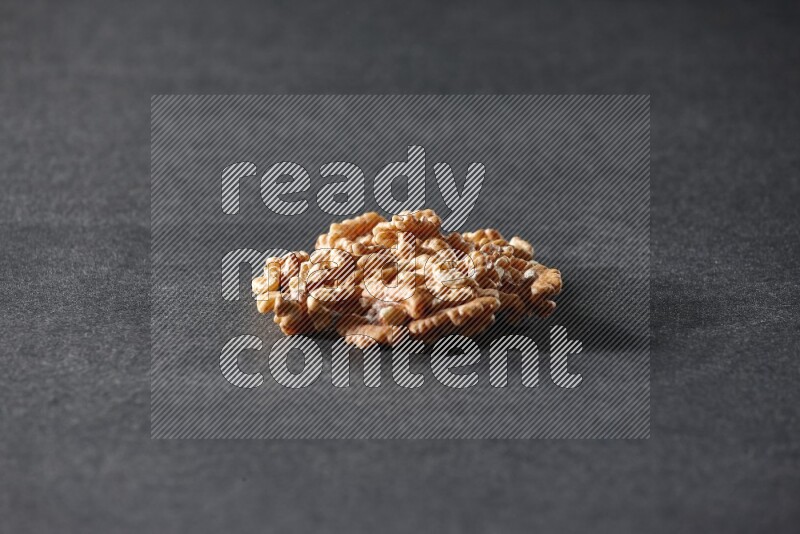 A bunch of walnuts on a black background in different angles