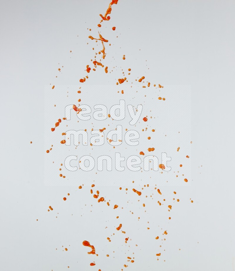 Orange liquid splash and drops on white background