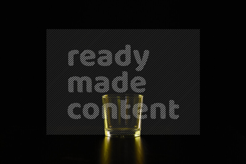 Glassware with rim light in yellow against black background