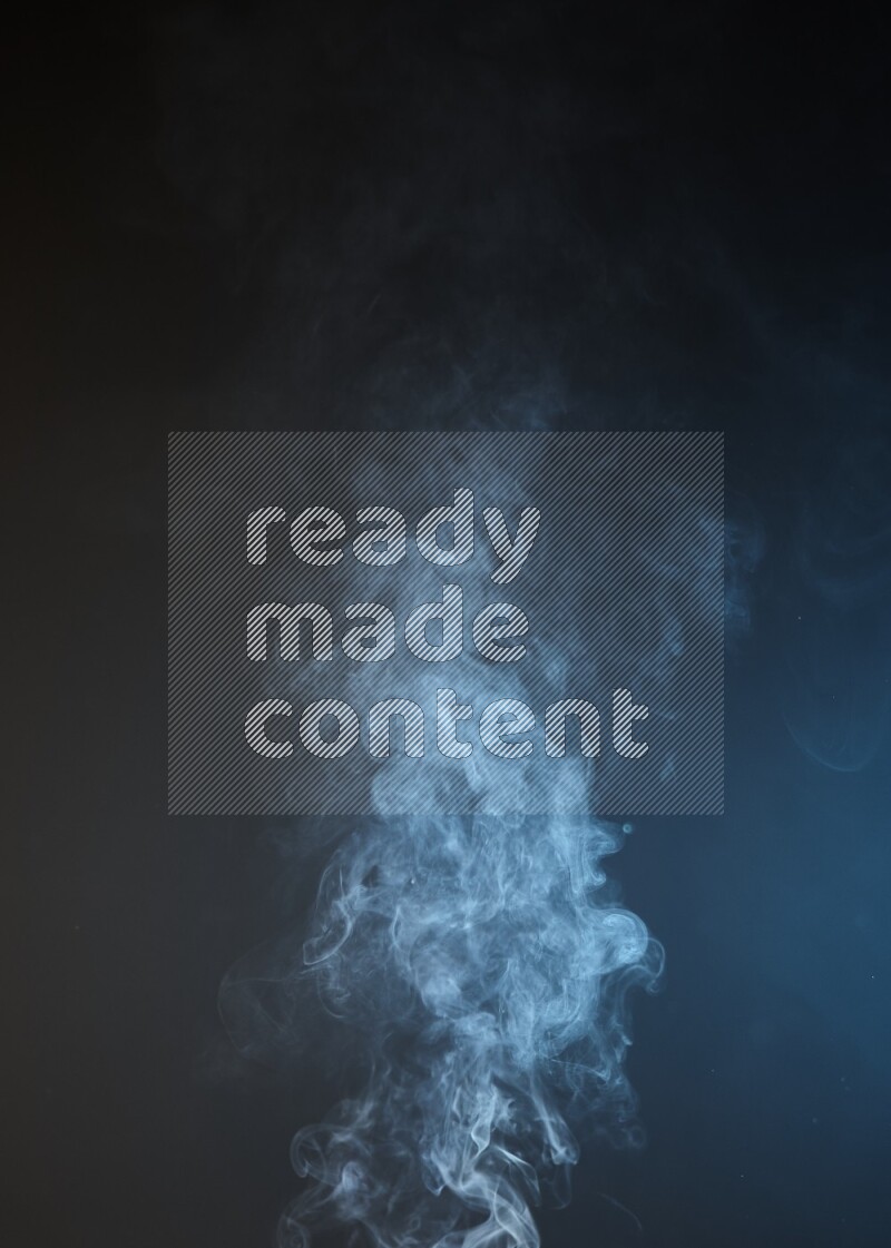 Heavy smoke in blue and yellow isolated on black background