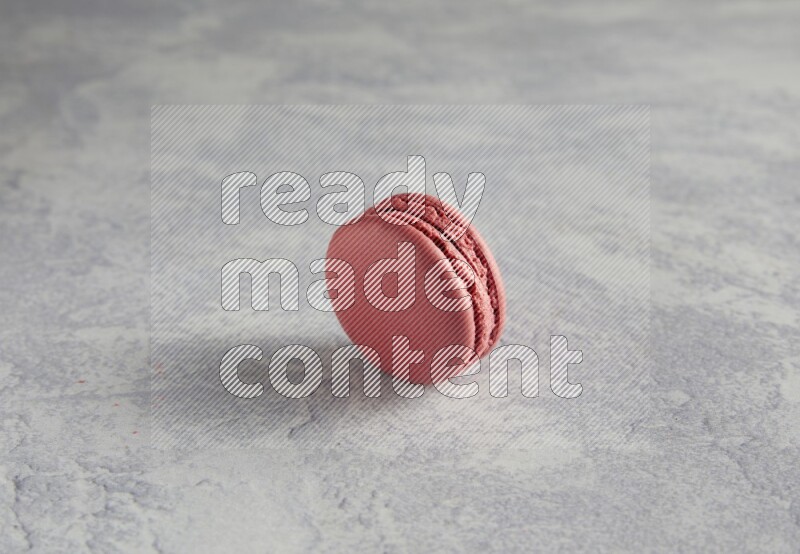 45º Shot of Pink Raspberry macaron on white  marble background