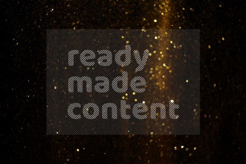 Gold glitter powder isolated on black background