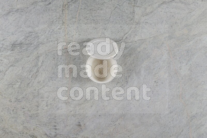 A multicolored pottery Cup on grey marble background