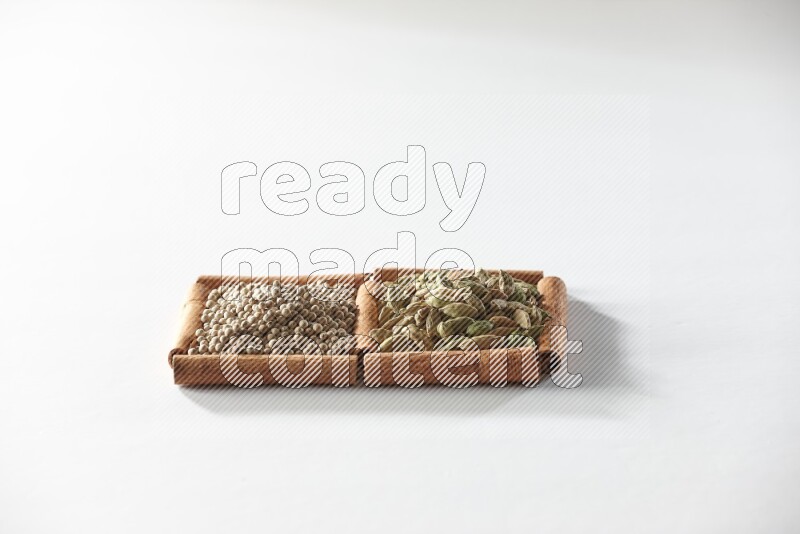 2 squares of cinnamon sticks full of cardamom and white pepper on white flooring
