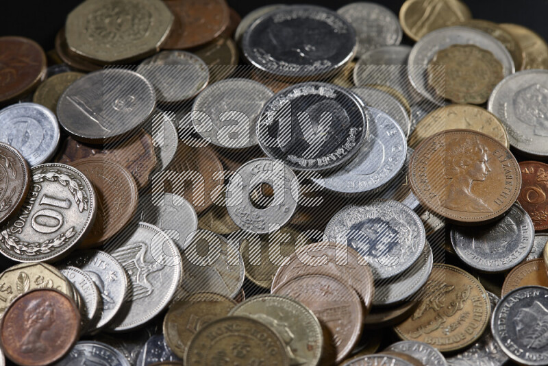 A close-ups of random old coins on black background