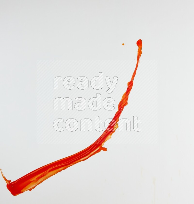 Orange liquid splash and drops on white background