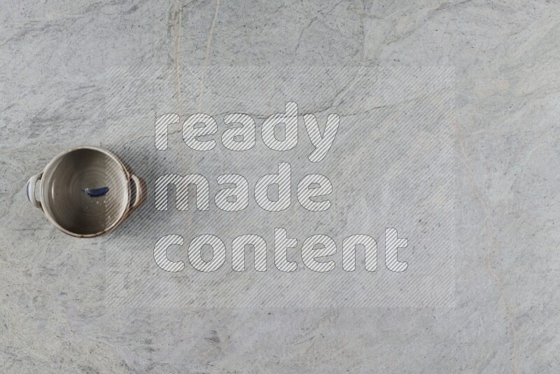 A multicolored pottery Bowl on grey marble background