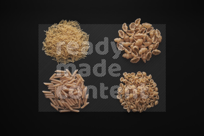 Different pasta types in bunches on black background