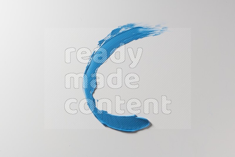A blue single curved painting knife stroke on a white background