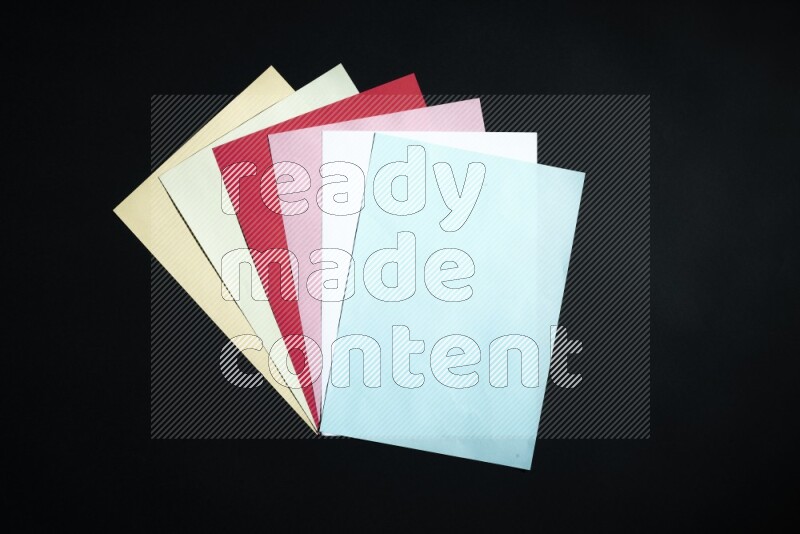 Multicolored paper sheet on black background