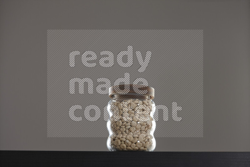 Lupin Beans in a glass jar on black background