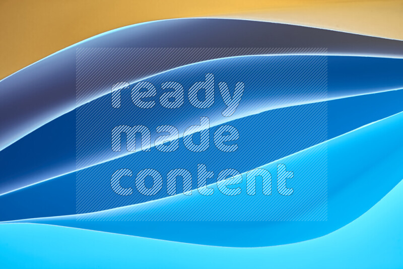 This image showcases an abstract paper art composition with paper curves in blue and yellow gradients created by colored light
