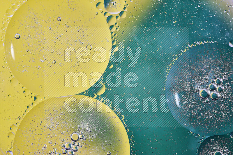 Close-ups of abstract oil bubbles on water surface in shades of green and yellow