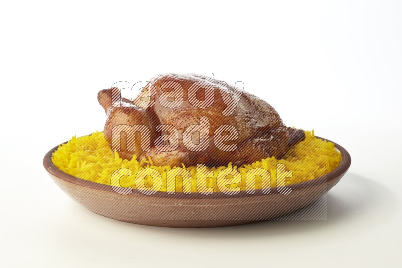 yellow basmati Rice with whole roasted chicken  on a pottery plate  direct  on white background
