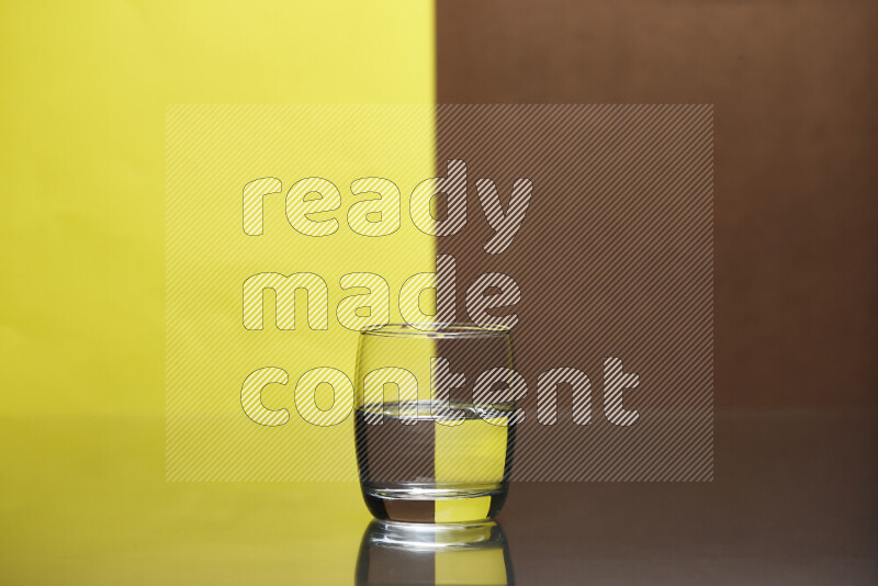 The image features a clear glassware filled with water, set against yellow and brown background
