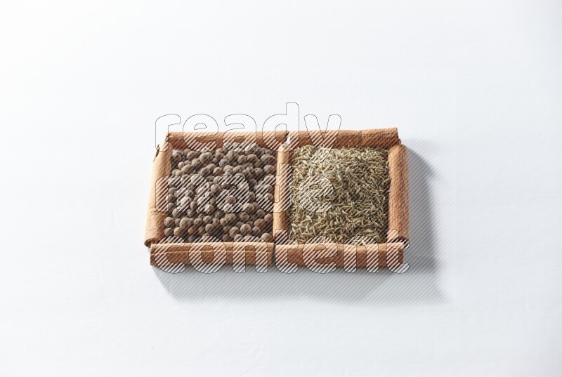 2 squares of cinnamon sticks full of allspice and cumin on white flooring