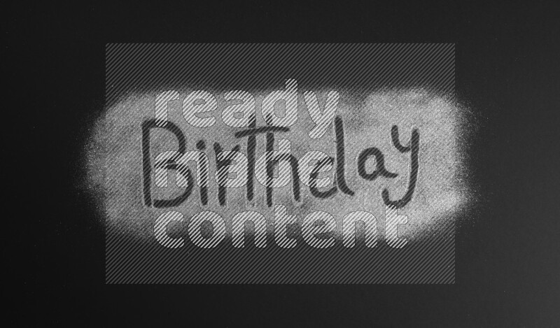 A word written with silver glitter on black background