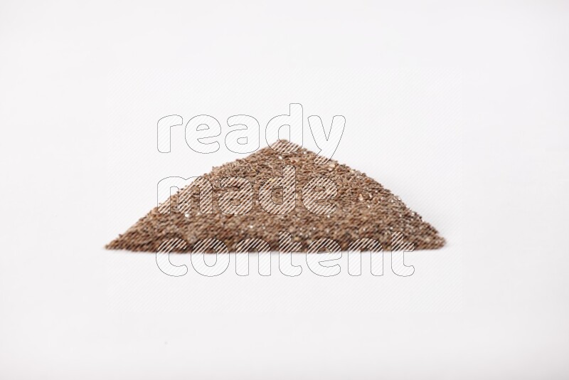 Flax seeds in a triangle shape on a white flooring