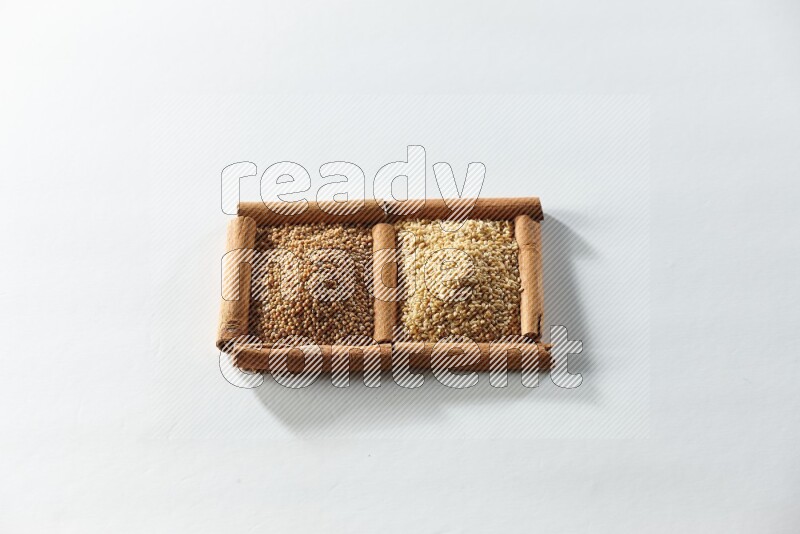 2 squares of cinnamon sticks full of mustard seeds and sesame on white flooring