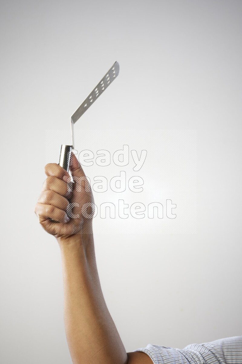 Male Hand Holding Burger Flipper on white background