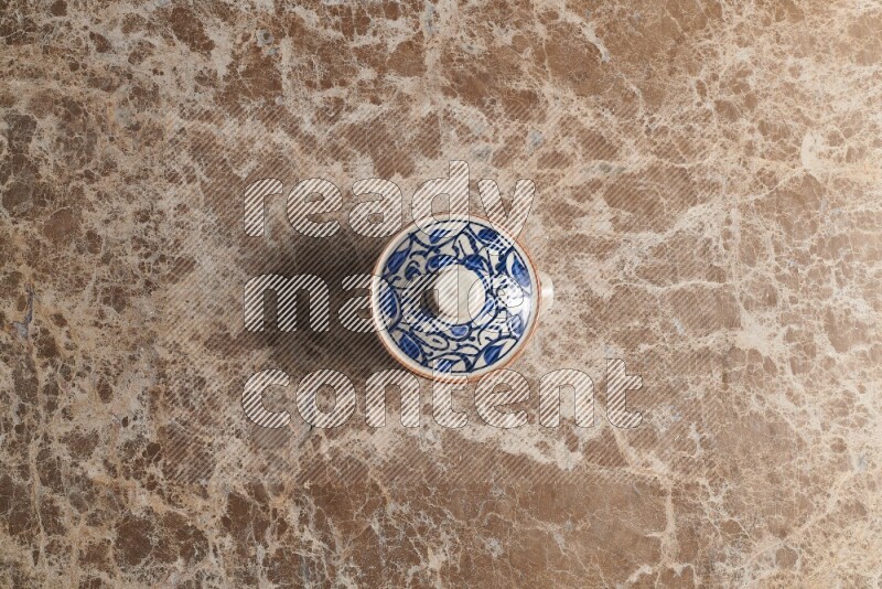 A multicolored pottery pot on beige marble background