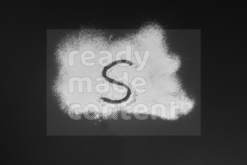 Alphabets written with powder on black background