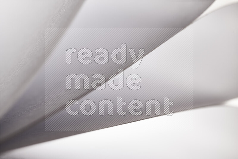 An abstract art showing grey paper sheets arranged in an overlapping curves