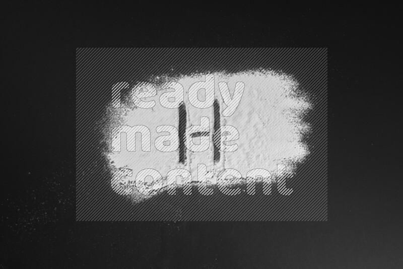 Alphabets written with powder on black background