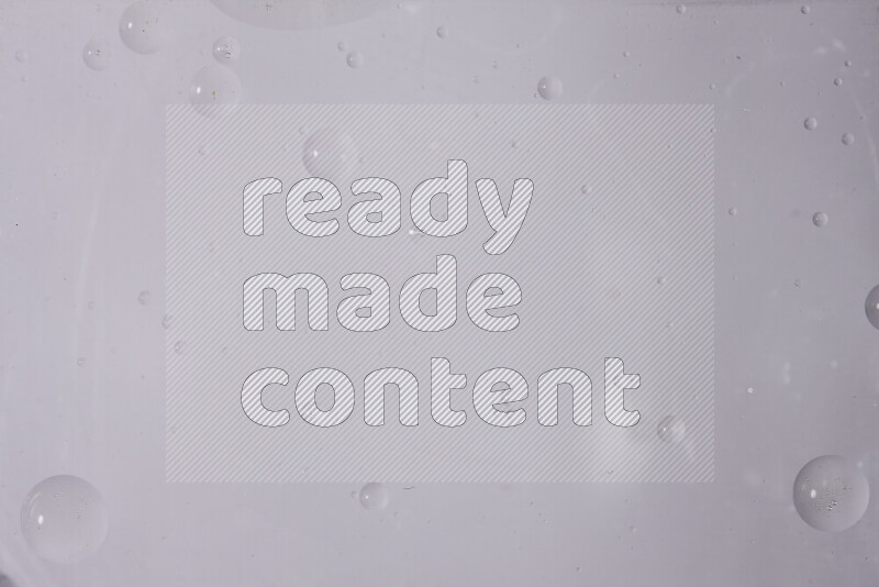 Abstract oil droplets in a water surface on white background