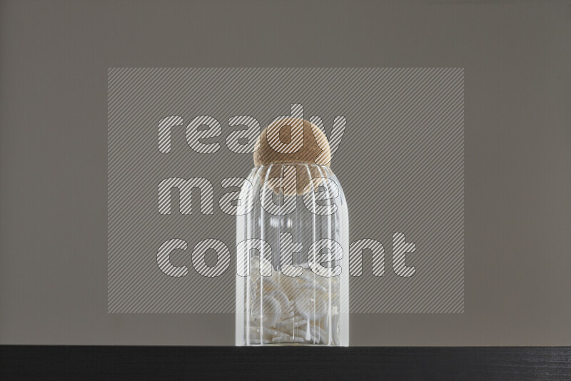 Buttons in a glass jar on black background