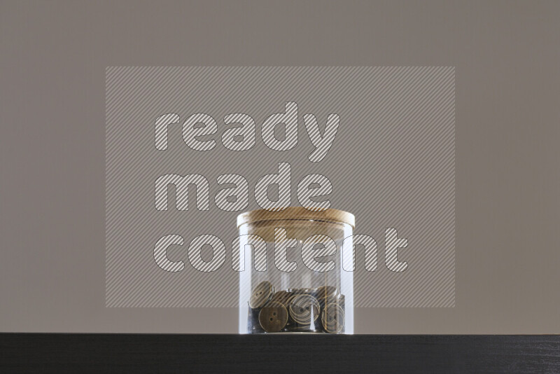 Buttons in a glass jar on black background