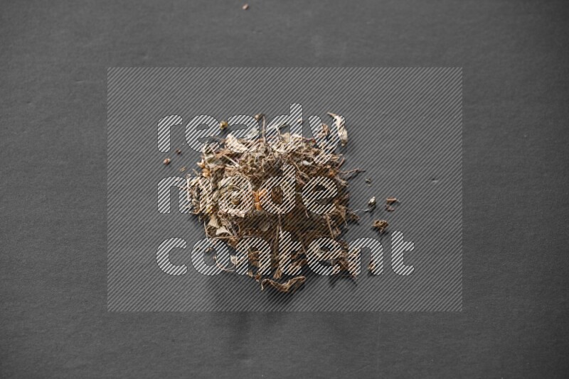 Dried basil on a black flooring