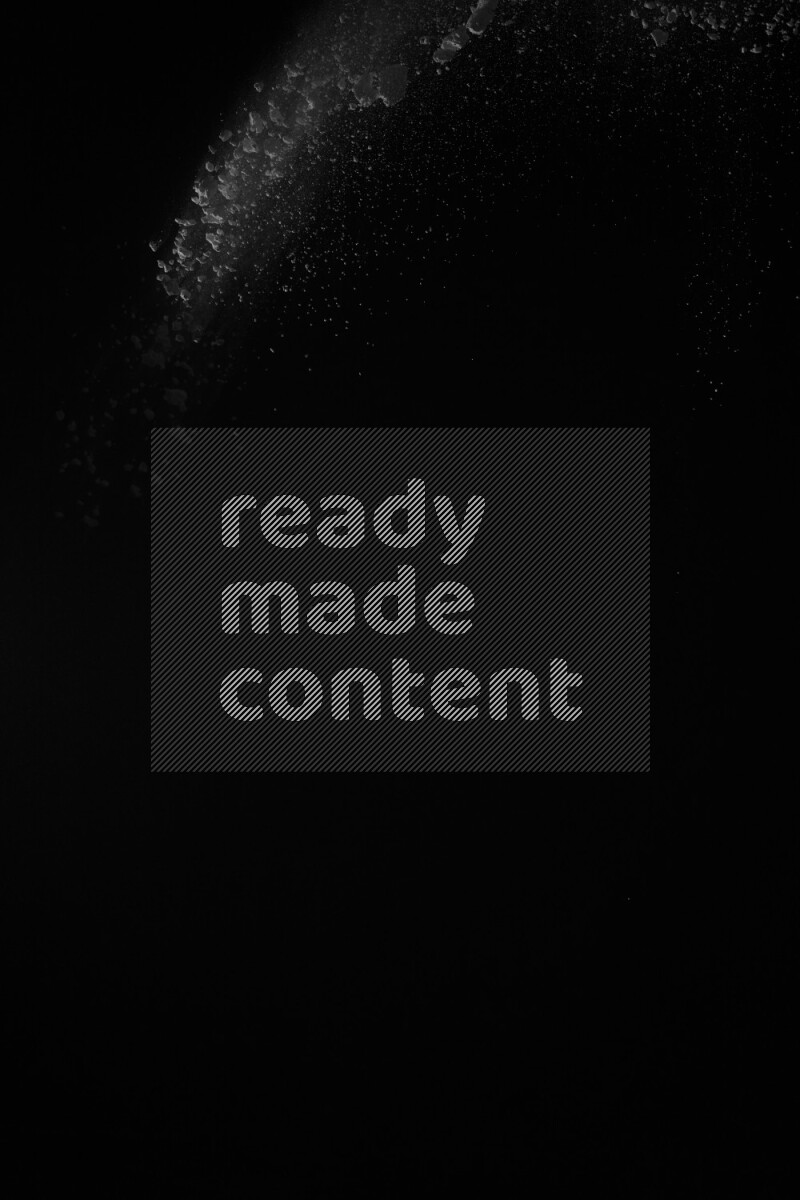 A side view of white powder explosion on black background
