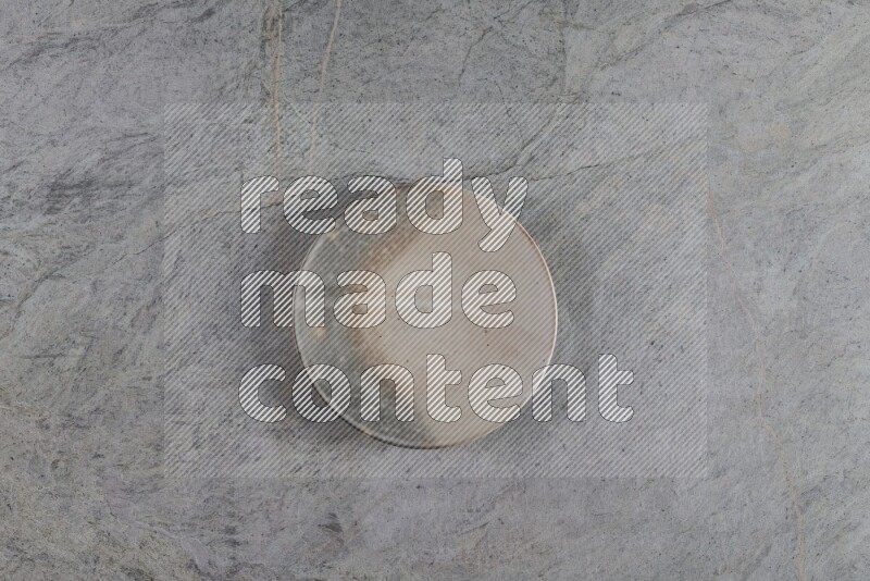 A multicolored pottery plate on grey marble background