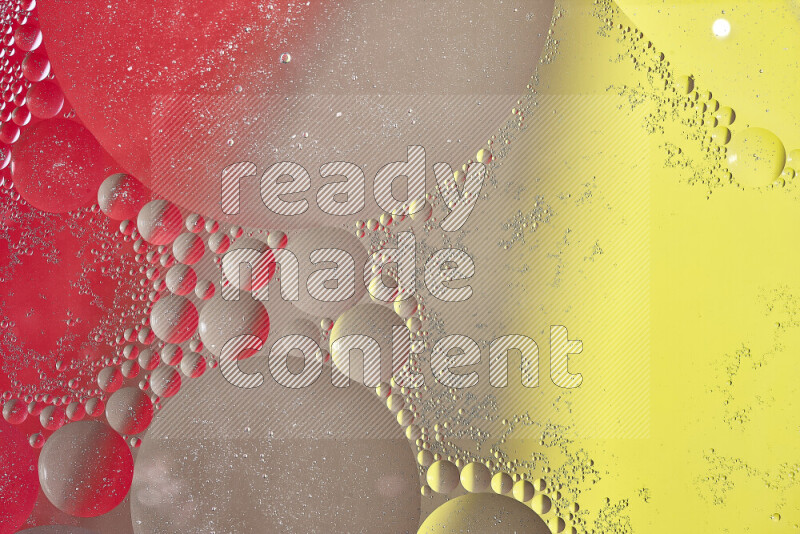 Close-ups of abstract oil bubbles on water surface in shades of yellow, red and brown