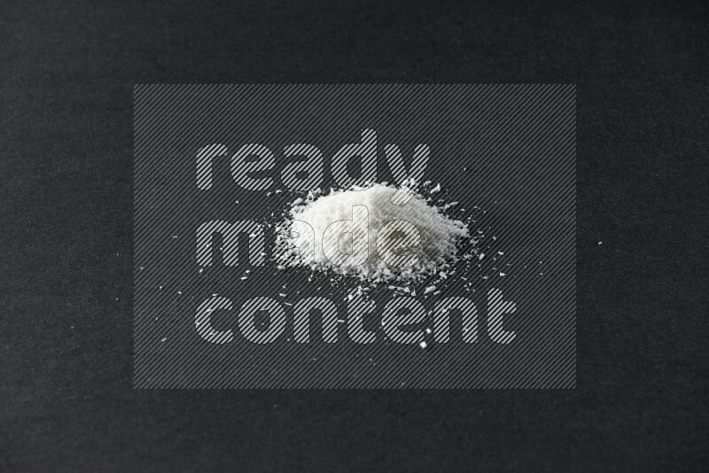 Desiccated coconut on a black background in different angles