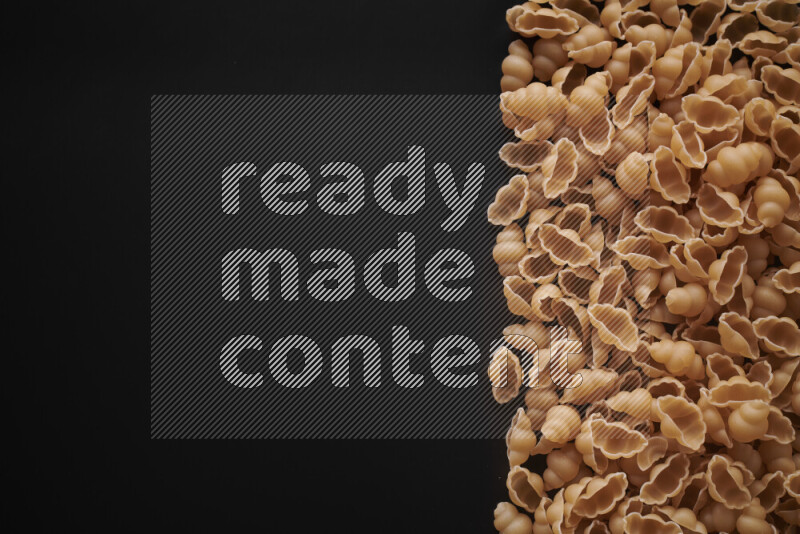 Different pasta types on black background