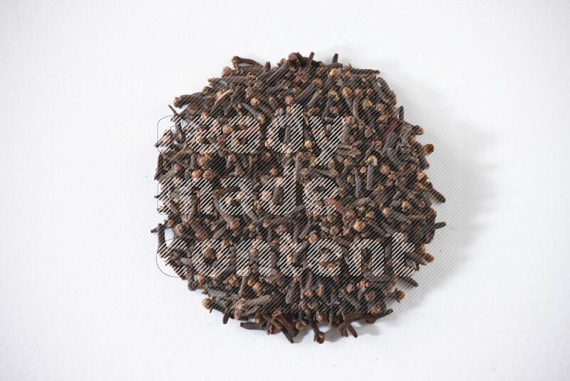 Cloves in a circle shape on a white flooring