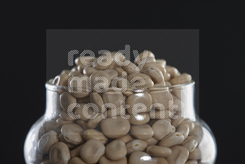 Lupin Beans in a glass jar on black background