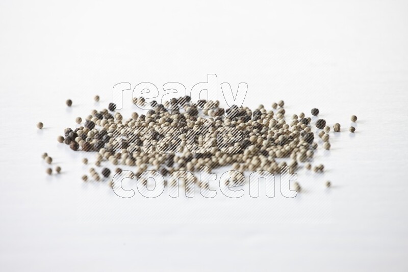 Mixed black and white pepper beads on a white flooring
