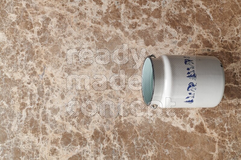 A vintage milk can on beige marble background