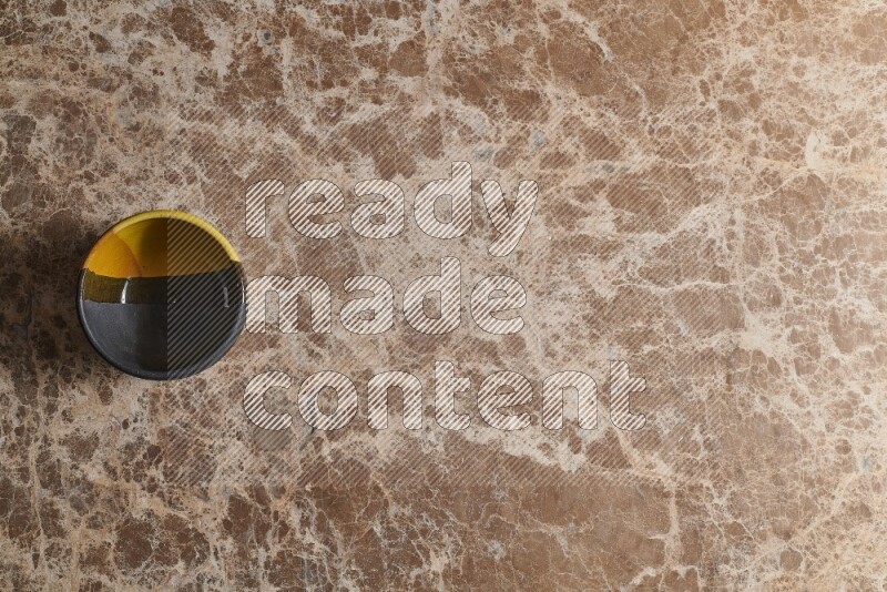 وعاء فخاري متعدد الألوان على خلفية من الرخام البيج