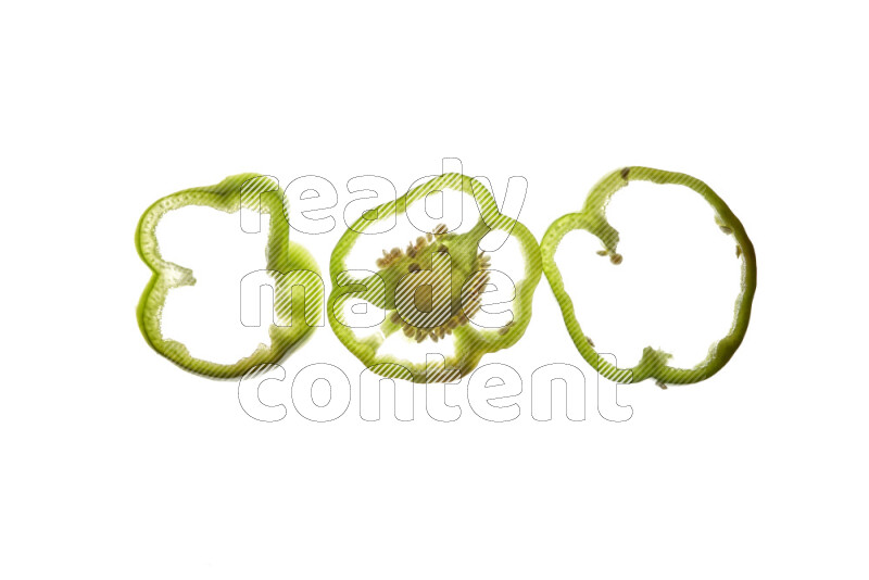 Green bell pepper slices on illuminated white background